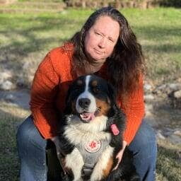 Woman with Bernese Mountain Dog service dog.